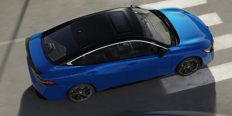 Black Nissan Sentra driving on road.